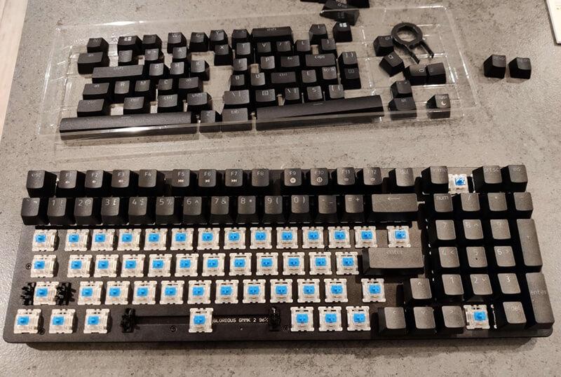 A half built keyboard with all of the switches inserted and half of the keycaps on