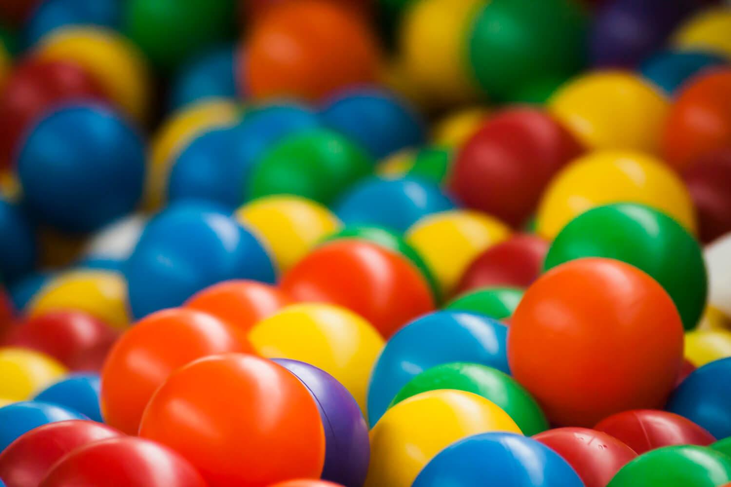 Closeup of brightly colored balls in a ball pit